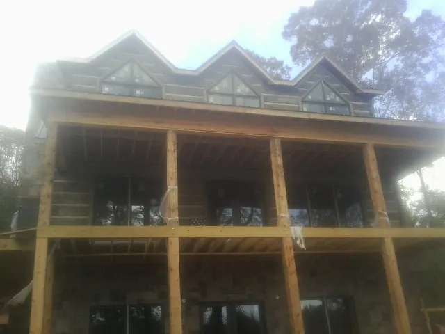 Dormers and porch framing on a large log home under construction in Placitas